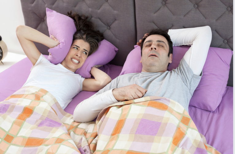 imagem mostrando homem roncando na cama e mulher incomoda com o barulho